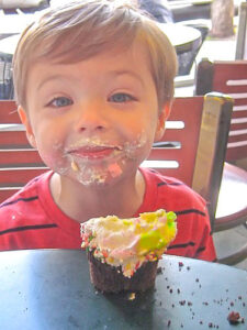 Little boy enjoying a cupcake at Murphys Bakery in Bad Axe Michigan. We have the best donuts, cupcakes and other baked goods in Michigan's thumb!